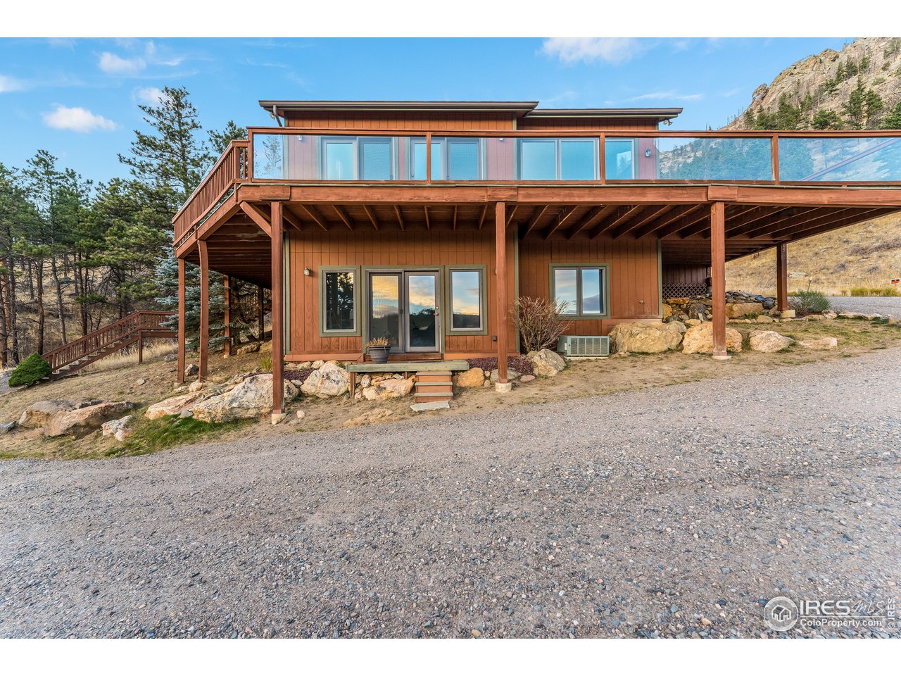 350 Stove Prairie Road Bellvue, CO 80512 - Photo 2 of 24 a front view of a house with a yard
