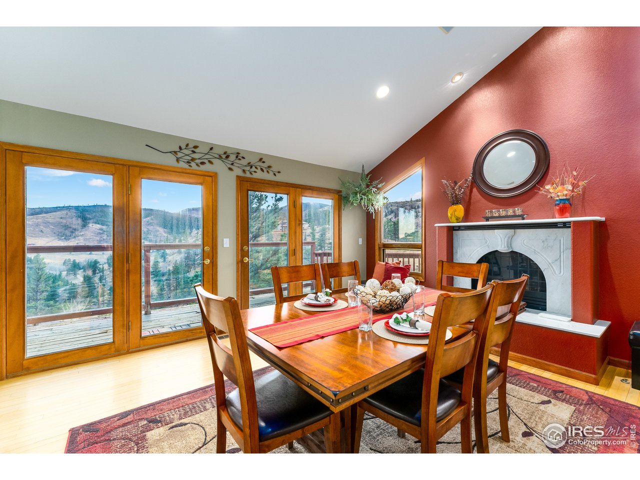 350 Stove Prairie Road Bellvue, CO 80512 - Photo 8 of 24 a dining room with furniture and a floor to ceiling window