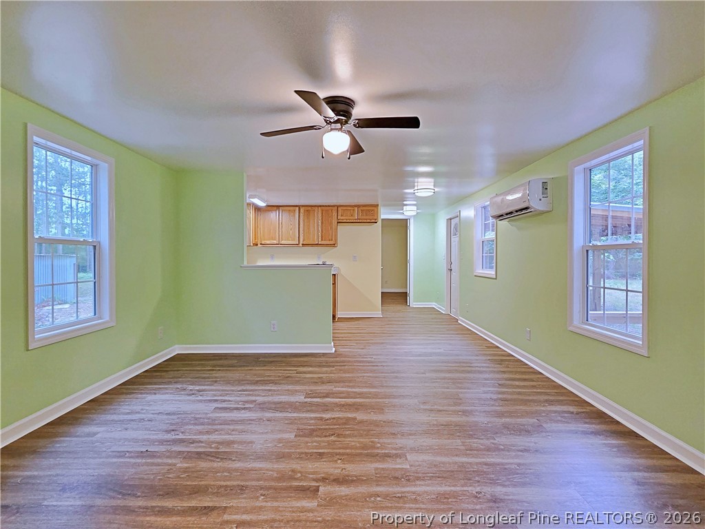 1031 Pine Acres Road White Oak, NC 28399 - Photo 5 of 29 a view of an empty room with window and wooden floor