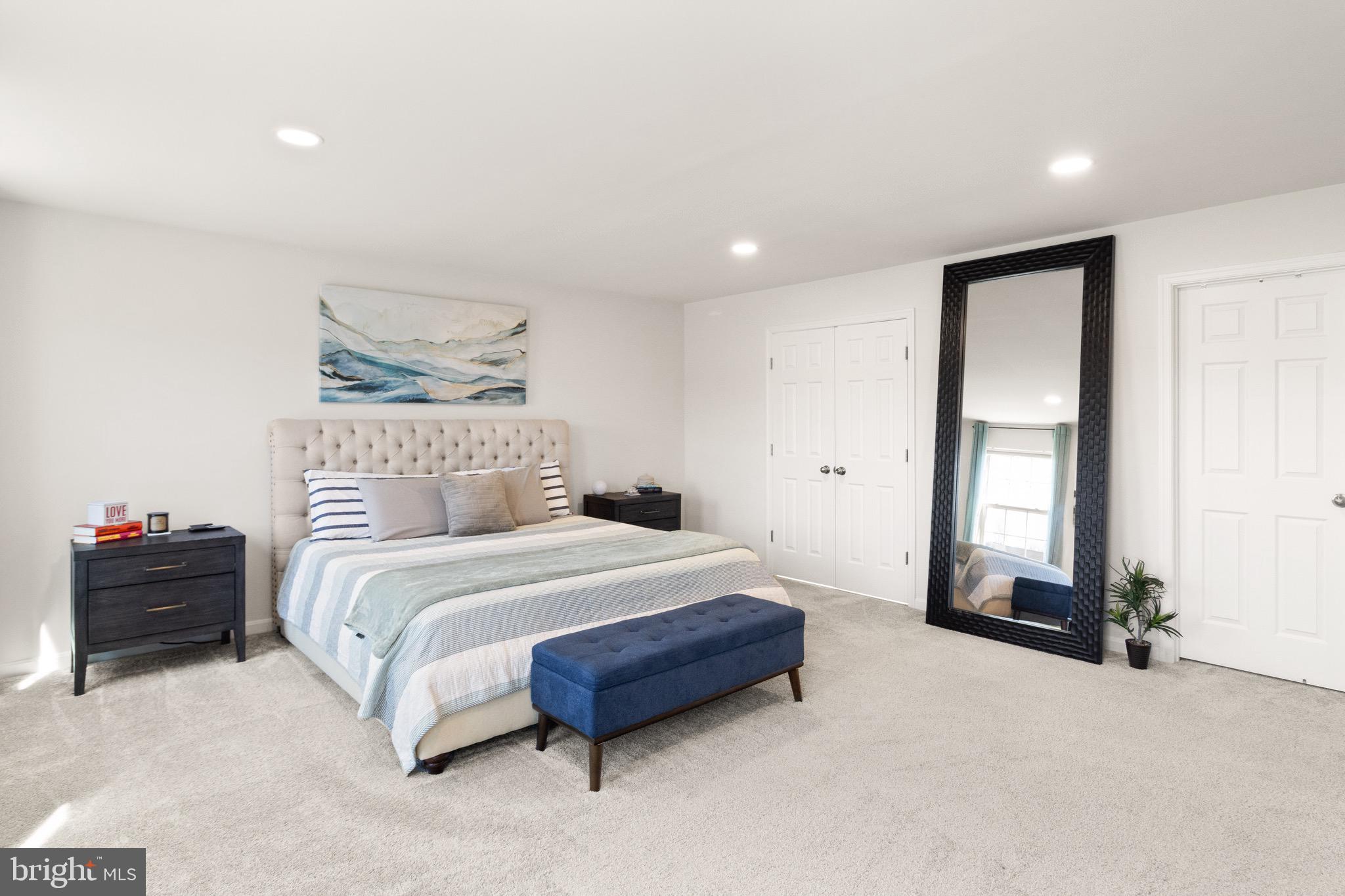 15911 Aerial View Road Woodbridge, VA 22193 - Photo 21 of 48 a spacious bedroom with a bed and a large mirror