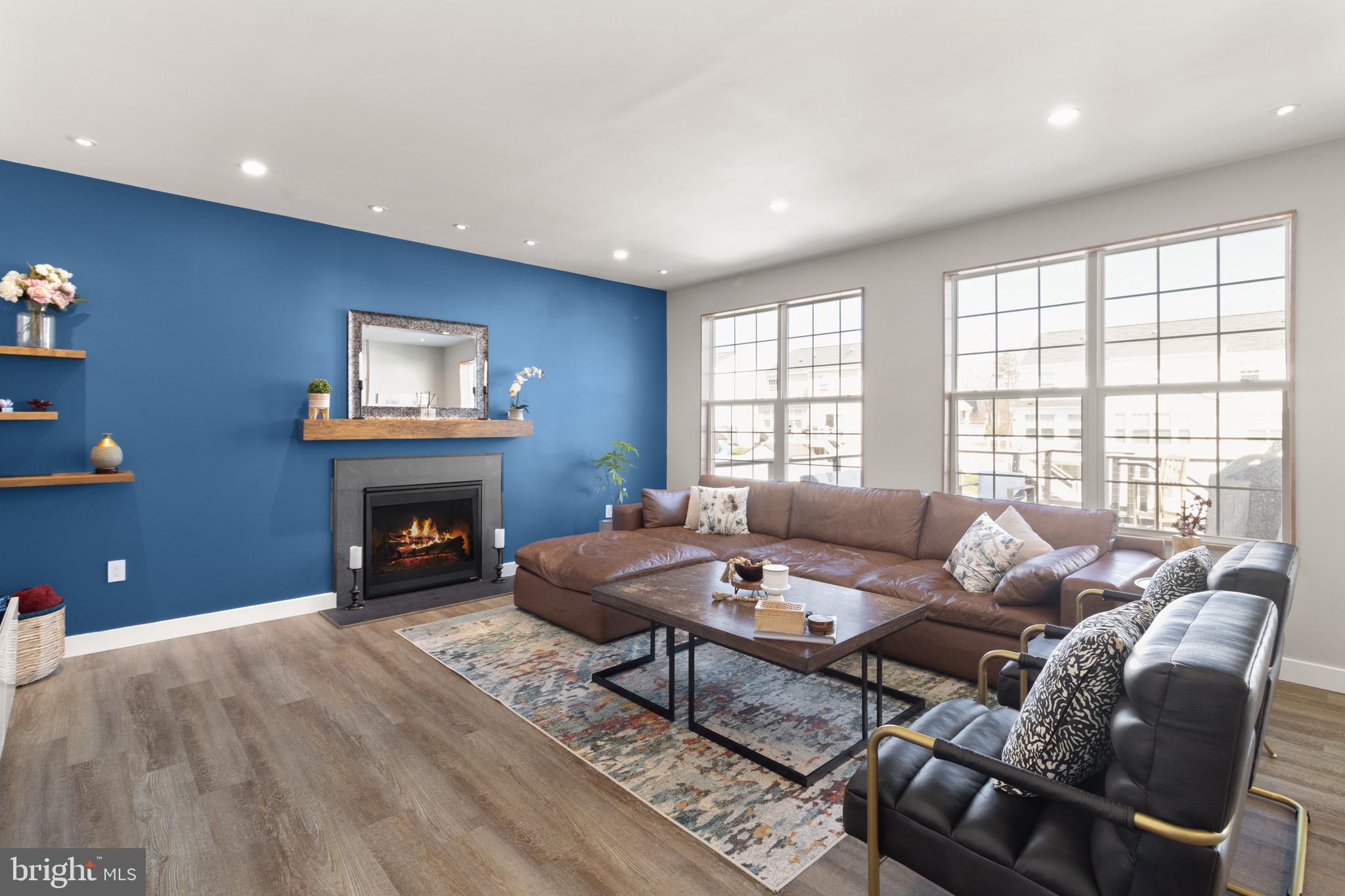 15911 Aerial View Road Woodbridge, VA 22193 - Photo 3 of 48 a living room with furniture a fireplace and a floor to ceiling window