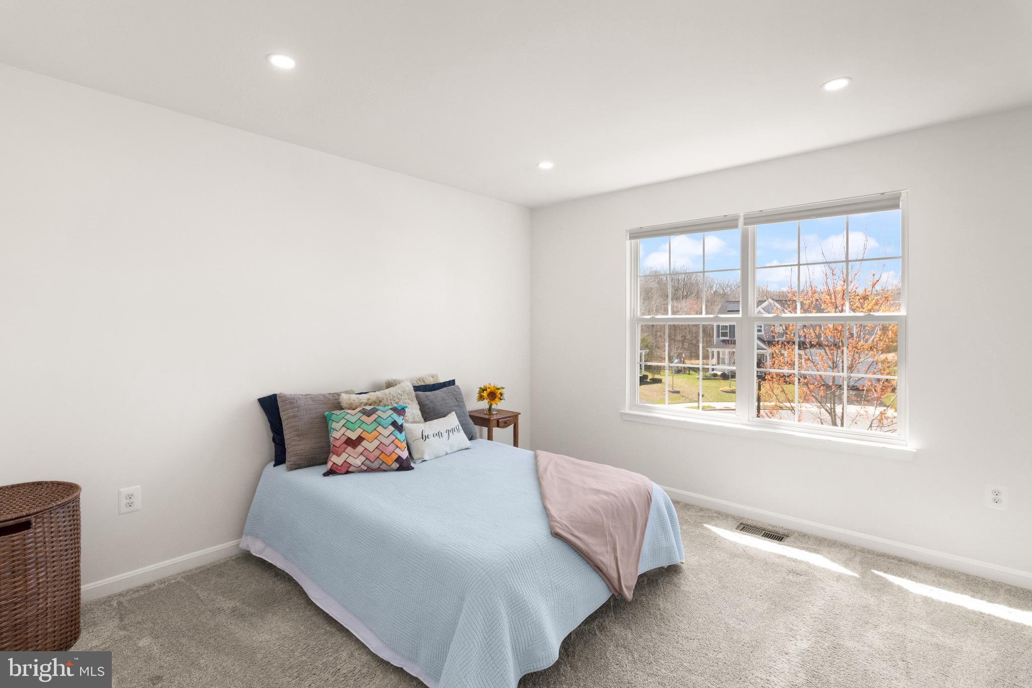 15911 Aerial View Road Woodbridge, VA 22193 - Photo 31 of 48 a bed sitting in a bedroom next to a window