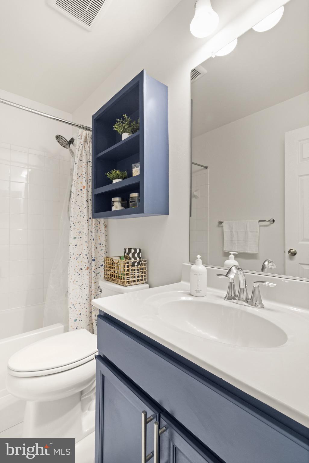 15911 Aerial View Road Woodbridge, VA 22193 - Photo 33 of 48 a bathroom with a sink a toilet a mirror and shower