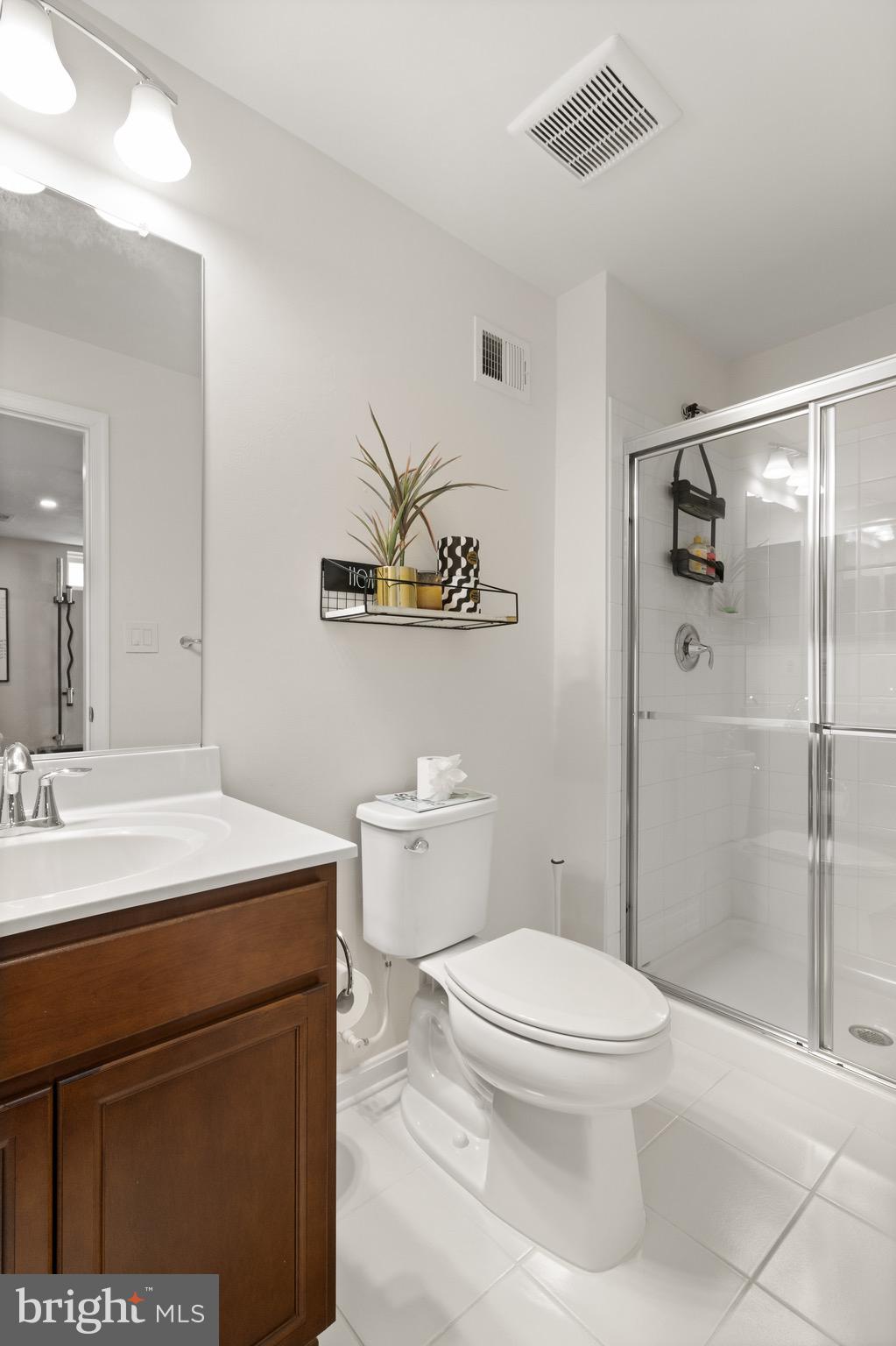 15911 Aerial View Road Woodbridge, VA 22193 - Photo 40 of 48 a bathroom with a toilet a sink and shower