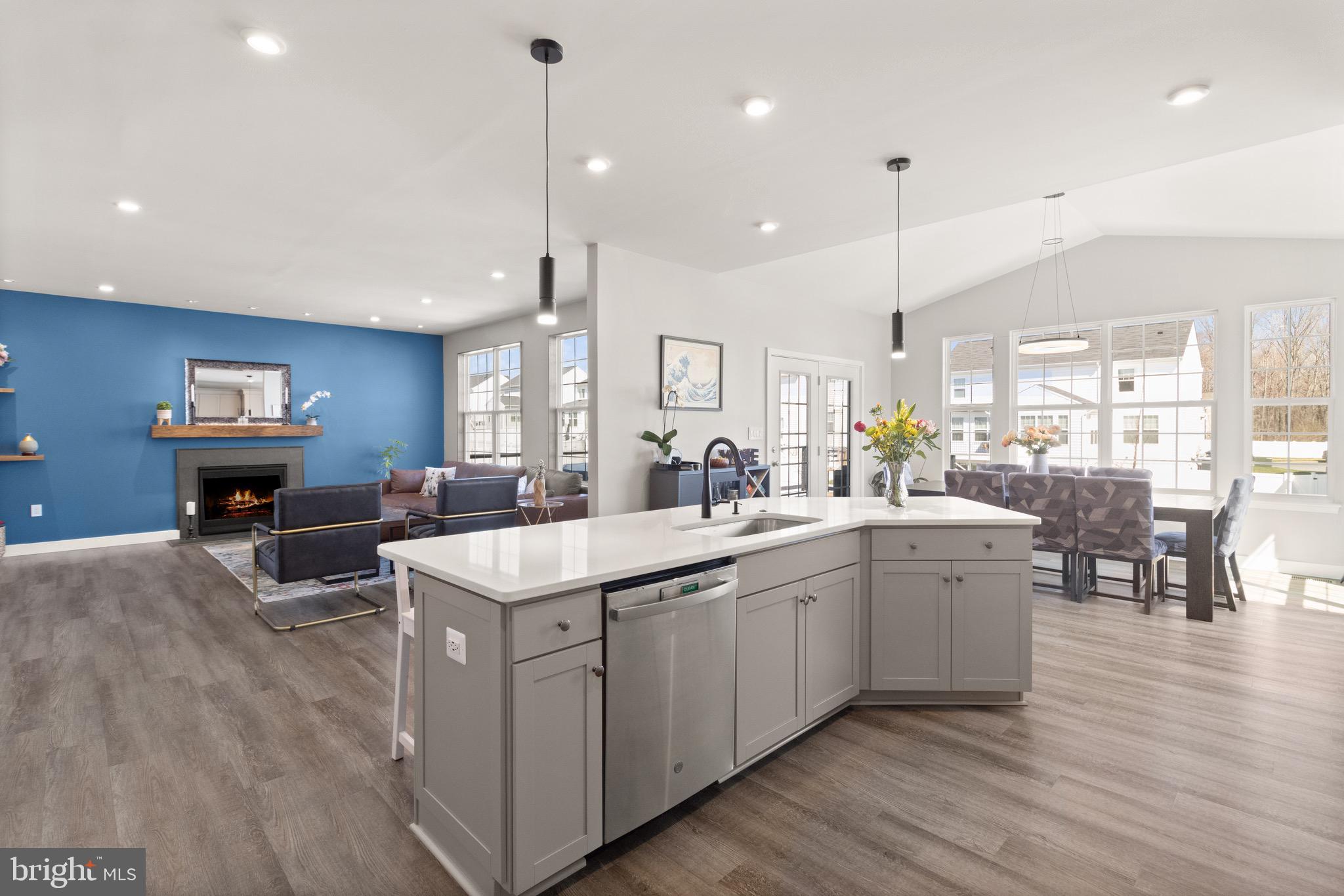 15911 Aerial View Road Woodbridge, VA 22193 - Photo 5 of 48 a large kitchen with stainless steel appliances a stove a sink a oven a dining table and chairs with wooden floor