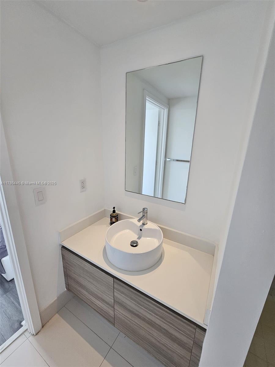 121 Northeast 34th Street, Unit 2511 Miami, FL 33137 - Photo 18 of 46 a bathroom with a sink and a mirror