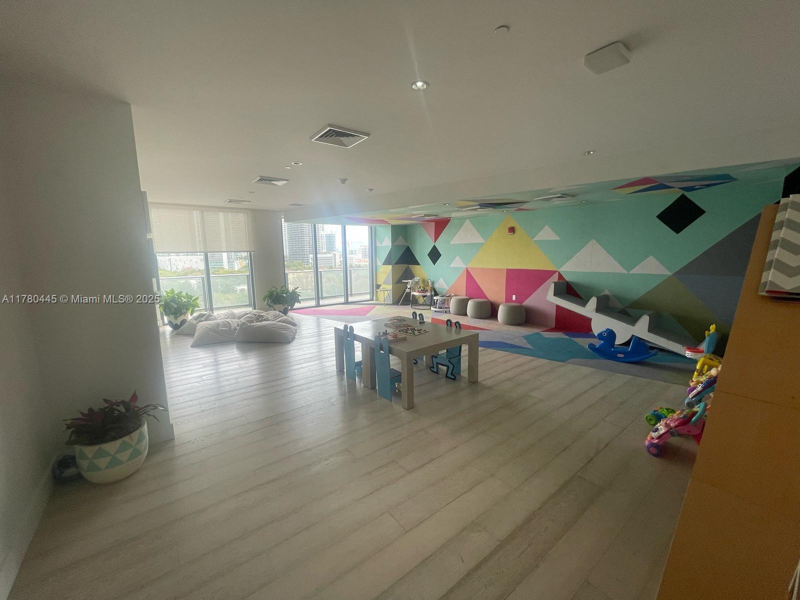 121 Northeast 34th Street, Unit 2511 Miami, FL 33137 - Photo 44 of 46 a living room with furniture and a wooden floor