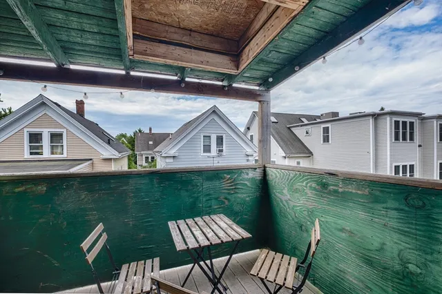 a view of a chair and table in the balcony
