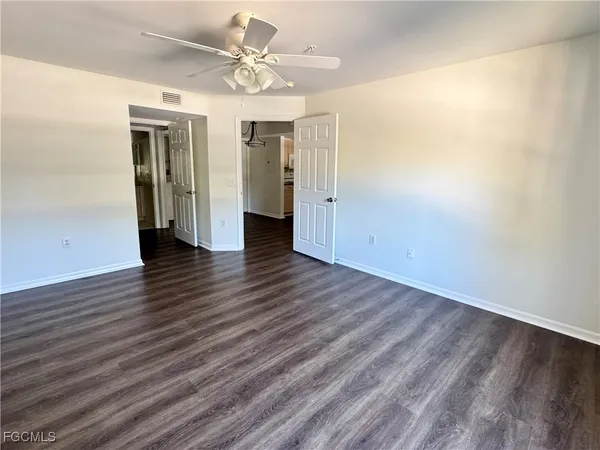 a view of an empty room with wooden floor