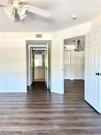 a view of a hallway view with wooden floor and staircase