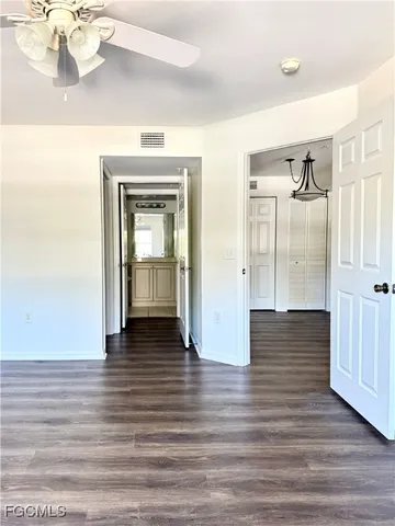 a view of a hallway view with wooden floor and staircase