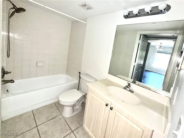 a bathroom with a bathtub sink mirror and toilet
