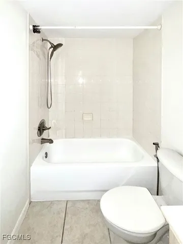 a bathroom with a toilet and a bathtub