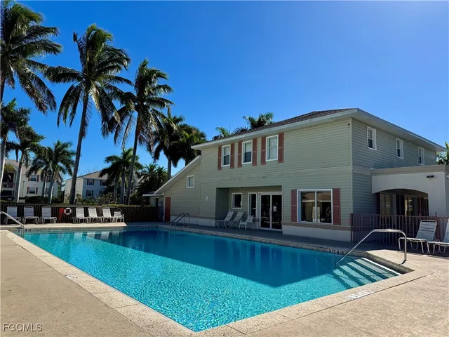 a front view of a house with swimming pool having outdoor seating