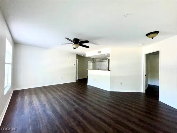 a view of a room with wooden floor and white walls