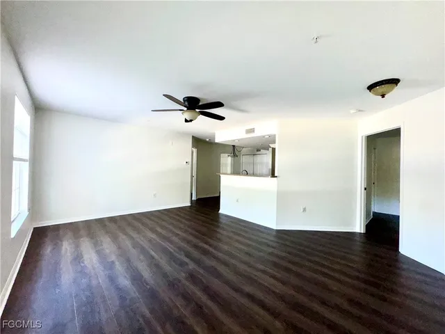 a view of a room with wooden floor and white walls