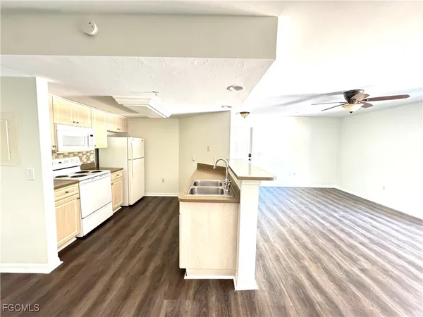 a kitchen with kitchen island a stove a sink and a refrigerator