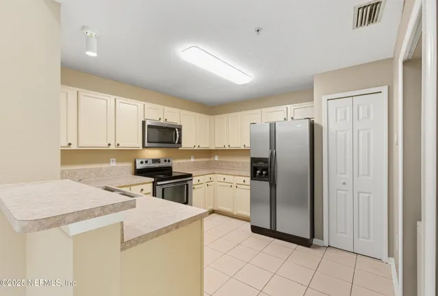 a kitchen with a refrigerator sink and microwave
