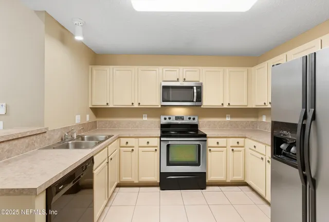 a kitchen with a sink appliances and cabinets