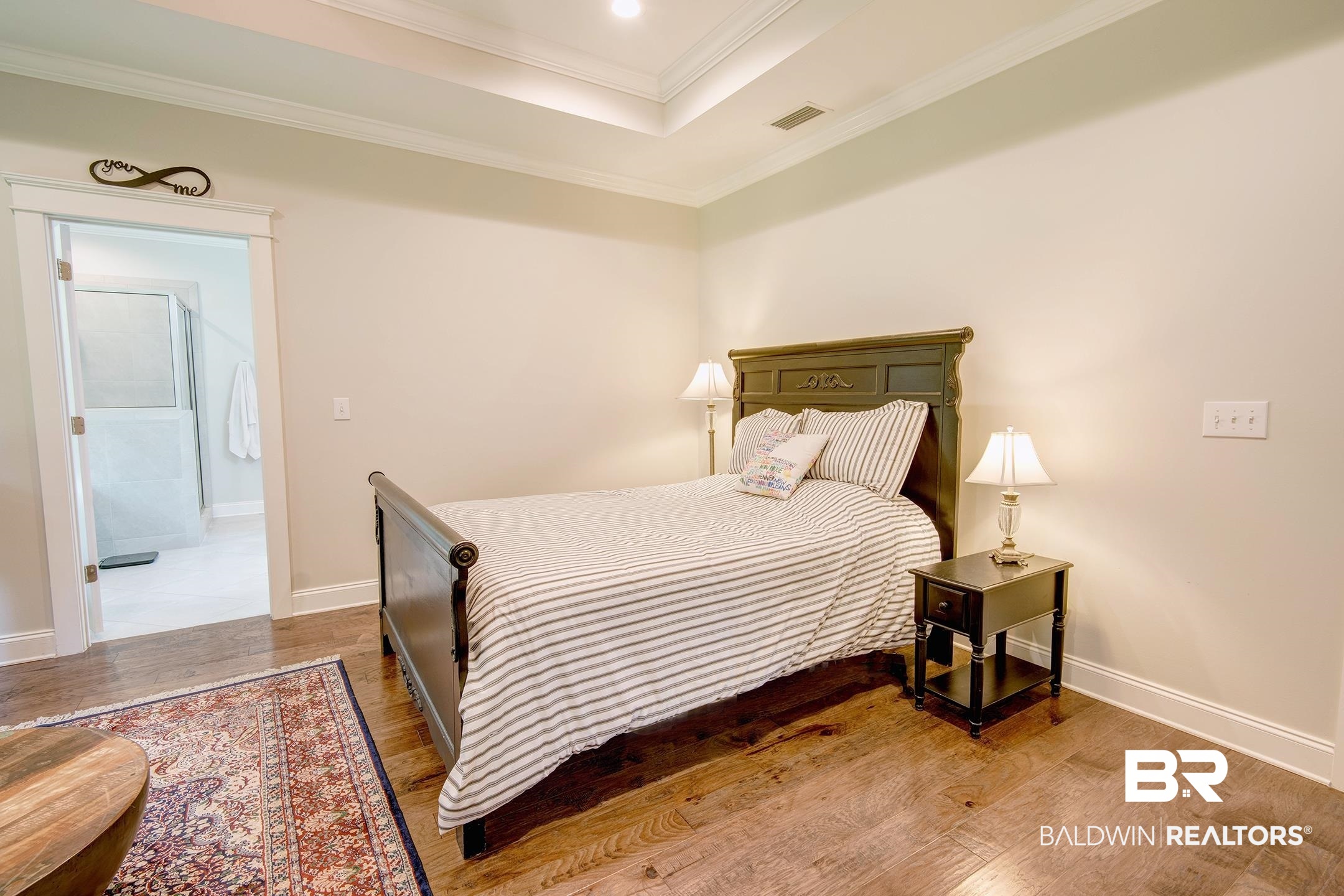 18754 Treasure Oaks Road Gulf Shores, AL 36542 - Photo 15 of 53 Spacious room featuring wood-finish flooring, a tray ceiling with recessed lighting, and white baseboards