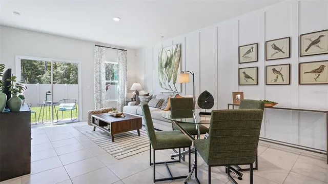 a work room with furniture and large windows