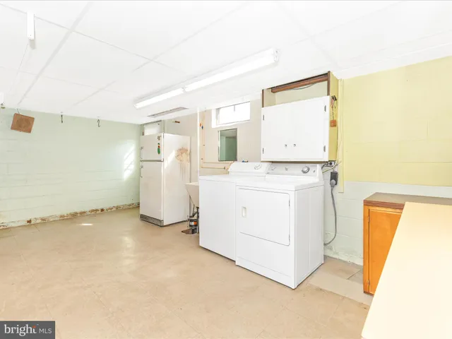 a view of a room with furniture and a window