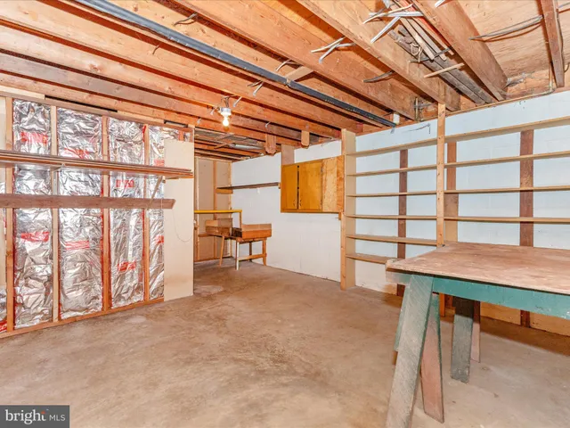 a view of an empty room with a table and chairs