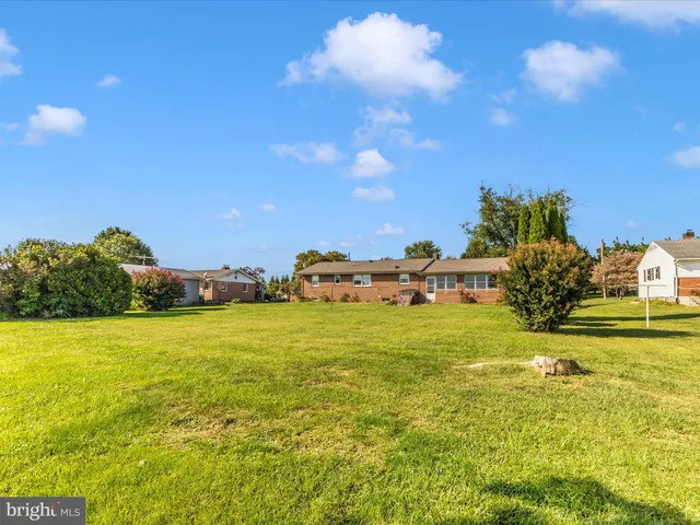 a front view of a house with a big yard
