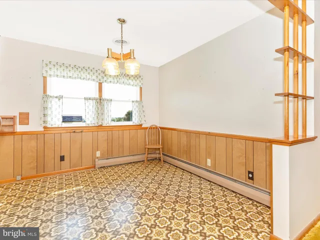 a view of a very nice looking dining room with a large window