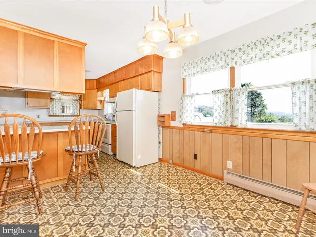 a large kitchen with a table and chairs