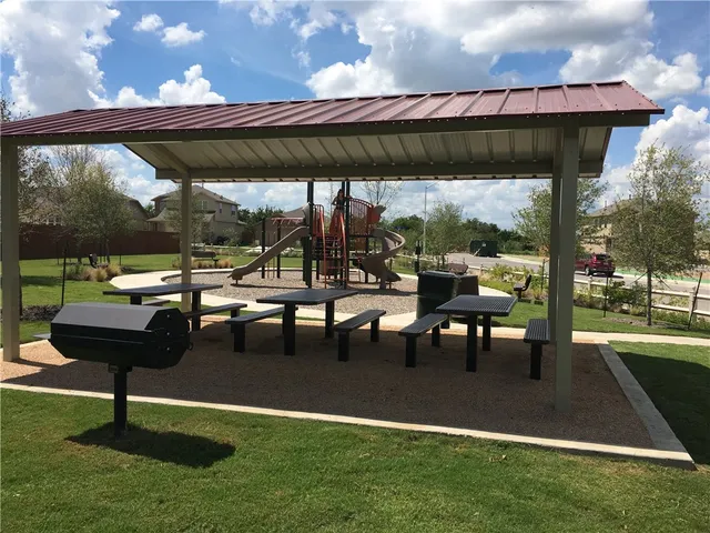 a view of a park with table and chairs