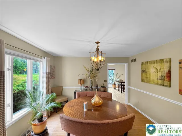 a dining room with furniture and wooden floor