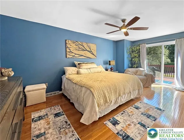 a bedroom with two beds and potted plant