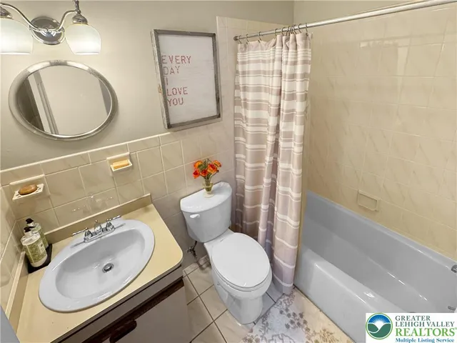 a bedroom with a bed a couch and a large window