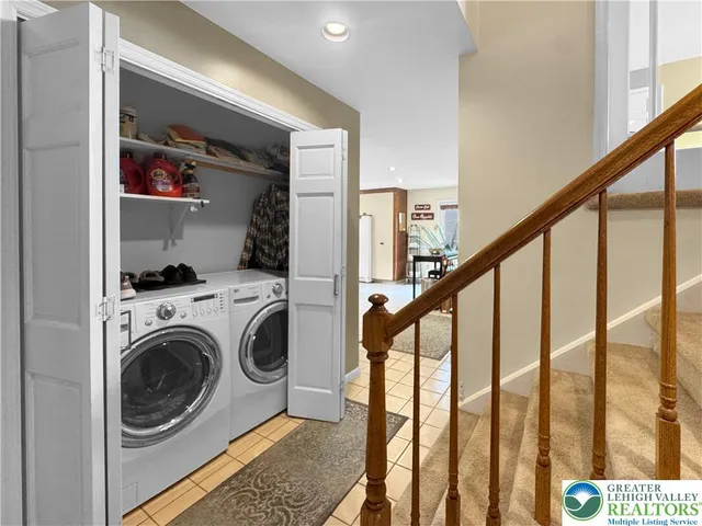 a living room with furniture a fireplace and a chandelier