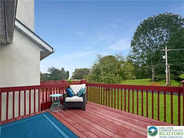 a view of a wooden deck with furniture