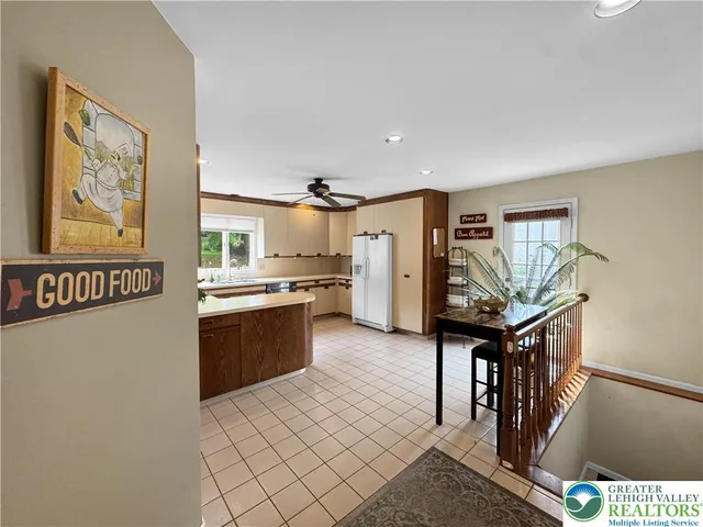 a kitchen with stainless steel appliances a refrigerator and a stove top oven