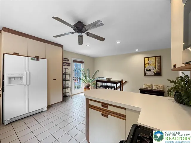 a kitchen with stainless steel appliances a refrigerator and a stove top oven