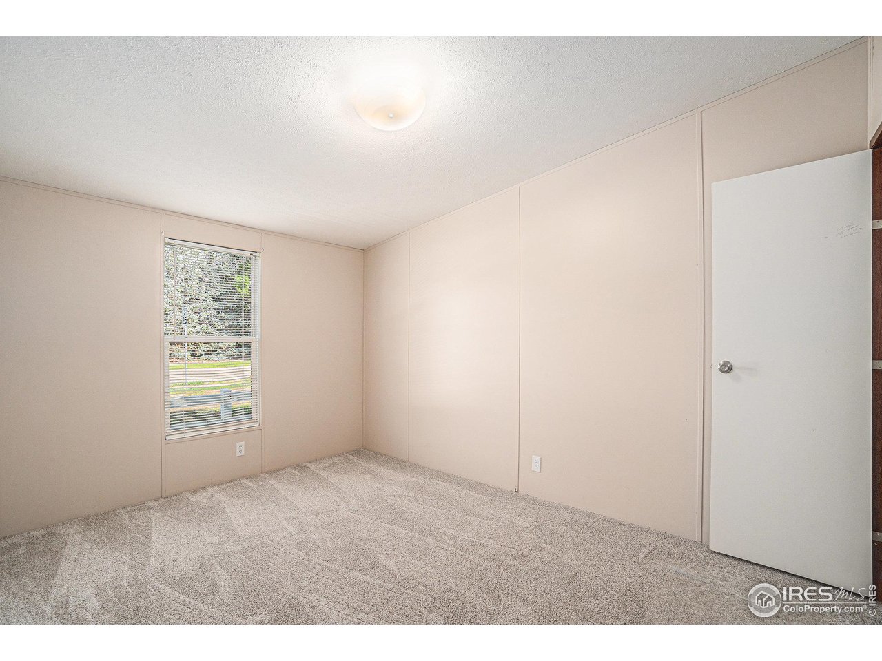 230 North 2nd Street, Unit 76A Berthoud, CO 80513 - Photo 9 of 13 a view of an empty room with a window