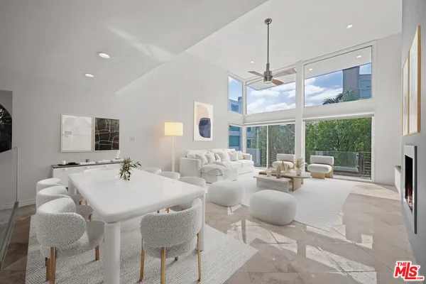 a living room with furniture chandelier and a large window