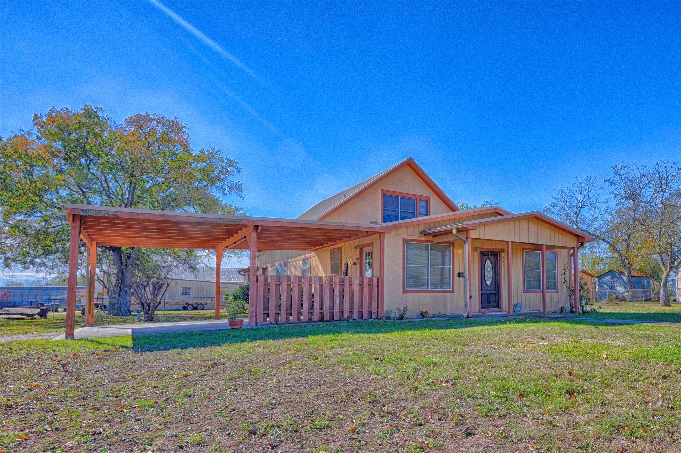 602 East Post Office Street Weimar, TX 78962 - Photo 2 of 21 a front view of a house with garden