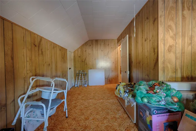 a bed room with a bed and a chair