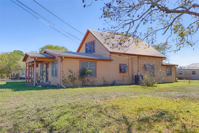 a view of a house with a yard and plants