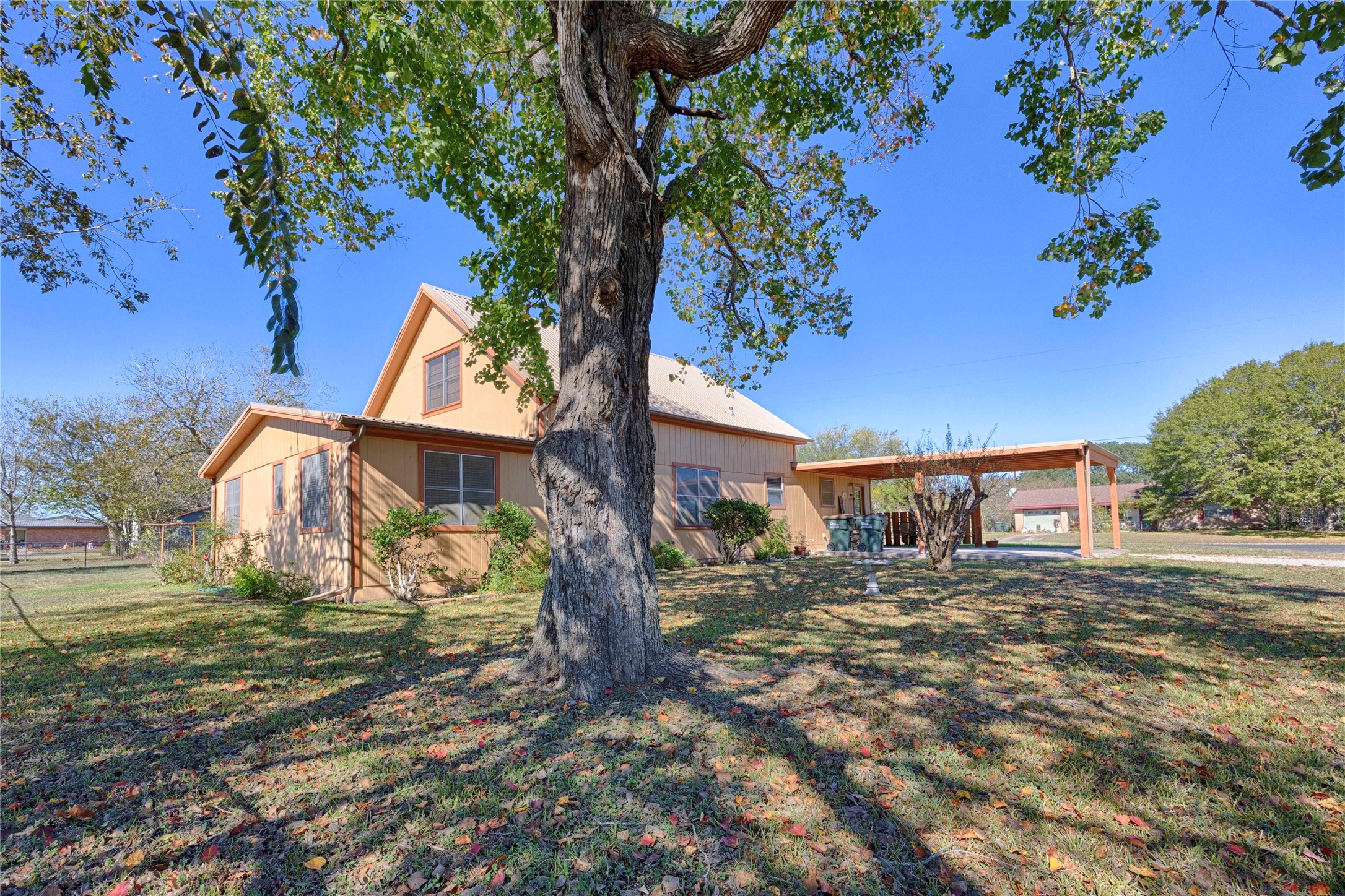 602 East Post Office Street Weimar, TX 78962 - Photo 4 of 21 a view of a yard with plants and a large tree