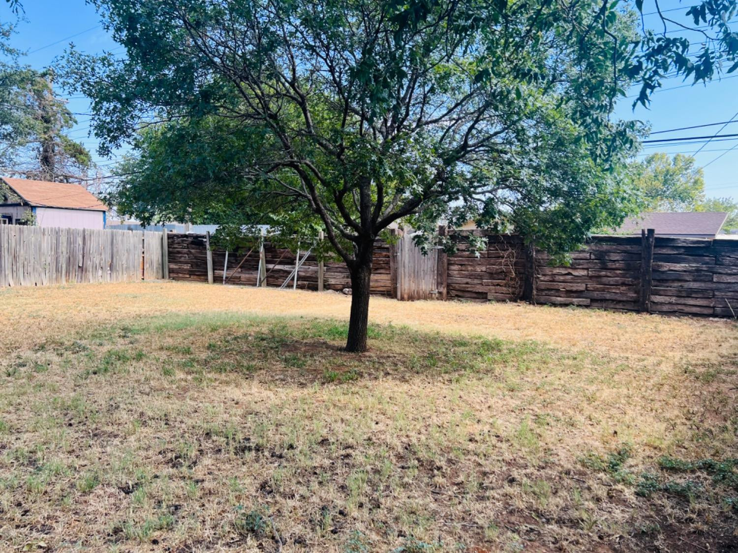 2107 57th Street Lubbock, TX 79412 - Photo 11 of 11 a view of a yard with wooden fence