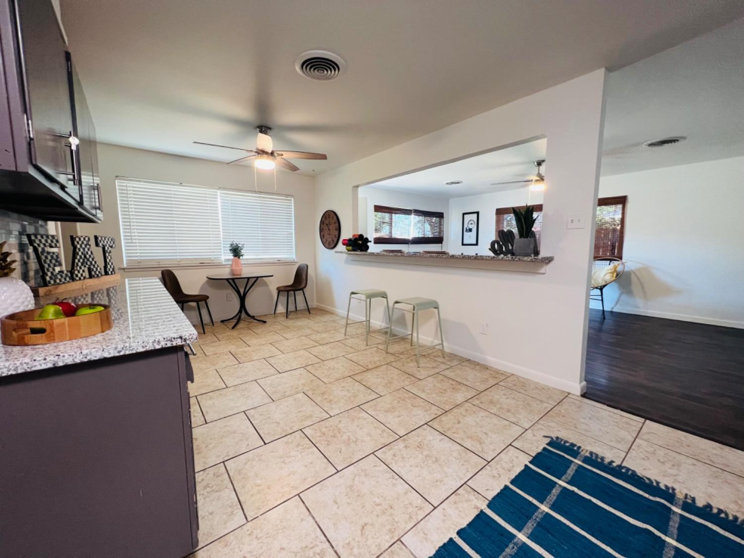 2107 57th Street Lubbock, TX 79412 - Photo 3 of 11 a living room with stainless steel appliances kitchen island granite countertop a sink and cabinets