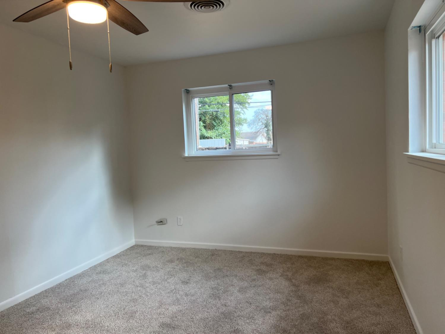 2107 57th Street Lubbock, TX 79412 - Photo 9 of 11 an empty room with windows