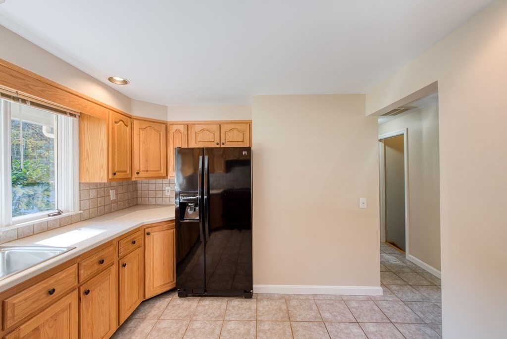 46 Prospect Street Sherborn, MA 01770 - Photo 11 of 40 a kitchen with granite countertop a refrigerator and a sink