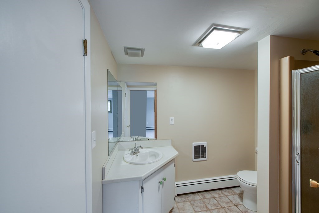 46 Prospect Street Sherborn, MA 01770 - Photo 18 of 40 a bathroom with a sink and mirror with toilet