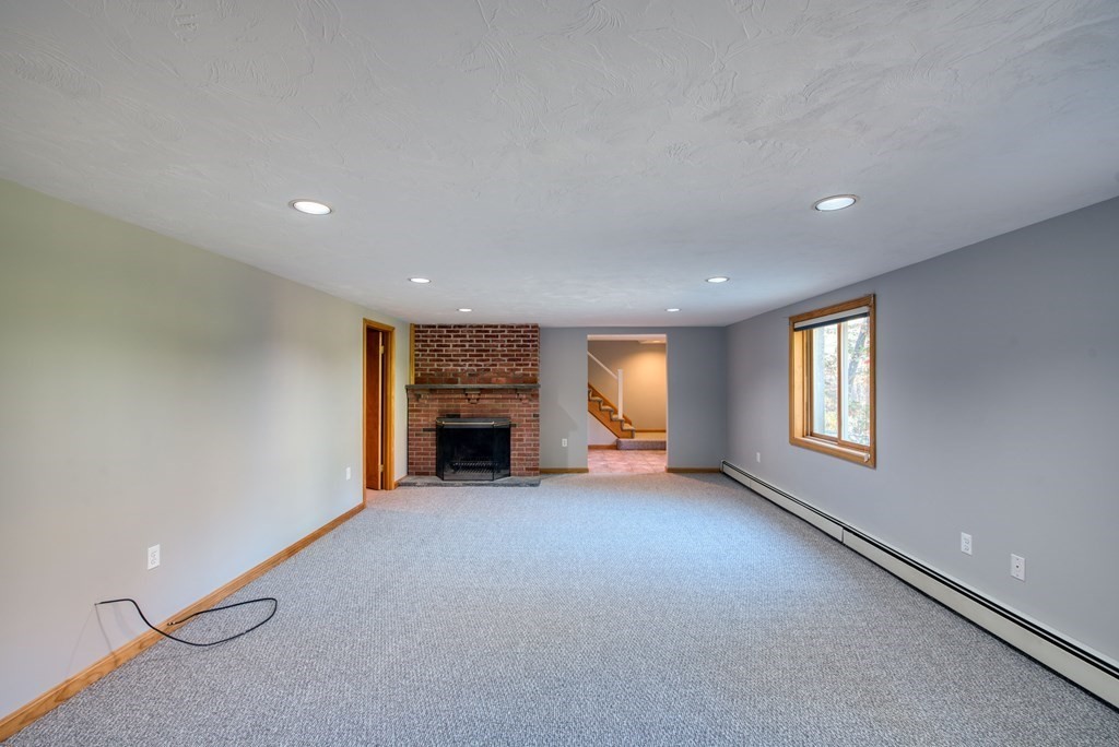 46 Prospect Street Sherborn, MA 01770 - Photo 21 of 40 an empty room with fireplace and windows